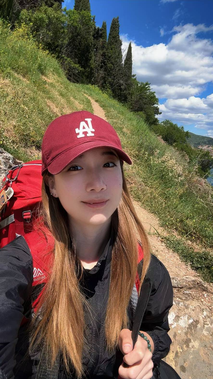 Yiyi hiking on a coastal trail