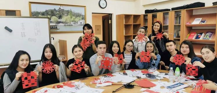 Students holding their Chinese paper-cutting work